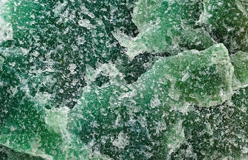 A polished green aventurine stone with a soft shimmer