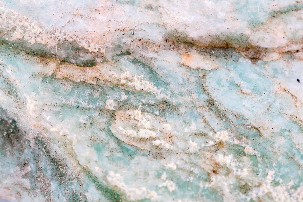 A polished amazonite stone in soft blue-green with pale streaks
